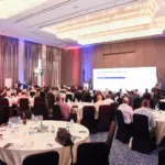 Round table seating and main presentation screen at a petroleum sector conference, managed by Sara Events in Egypt